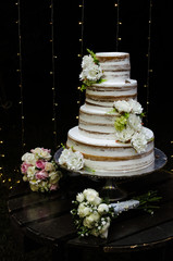 vanilla wedding cake decorated with flowers.
