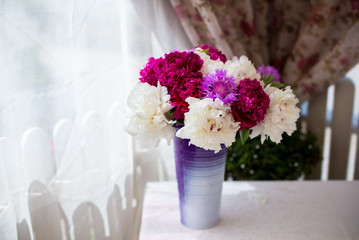 bouquet of flowers in a vase on wooden table