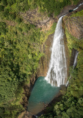 Obraz premium Aerial view of Manawaiopuna Falls and landscape of hawaiian island of Kauai from helicopter flight