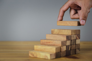 Hand Closer up hands of businessmen,stacking wooden blocks into steps,Concept of business growth success - image