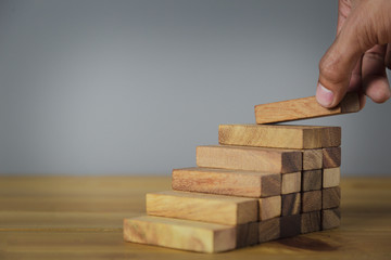 Hand Closer up hands of businessmen,stacking wooden blocks into steps,Concept of business growth success - image