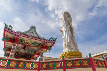 Fototapeta na wymiar Ancient Chinese Shrine with Big Three face Guanyin statue and sky background,public landmark for tourist