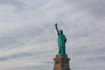 Fototapeta na wymiar Statue of Liberty against sky and clouds, in New York City, USA