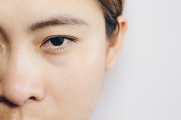 Fototapeta premium Close up headshot of adult woman with clean fresh skin isolated on white background. She open her eye.