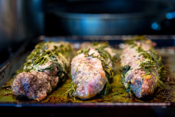 Juicy Roasting pork wrapped in herbs on a cookie sheet just out of the oven