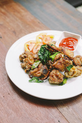 Thai style stir fried thighs chicken with salt and chili. Served with chili sauce.