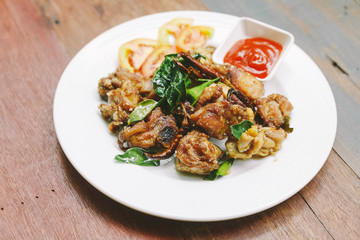 Thai style stir fried thighs chicken with salt and chili. Served with chili sauce.