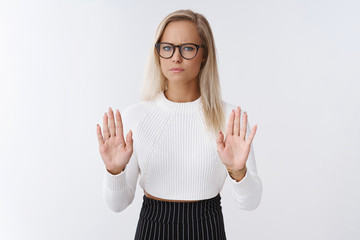Woman rejects disrespectful offer. Upset and displeased gloomy blond female businesswoman in...