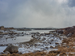 sea and sky in winter with ice and rocks