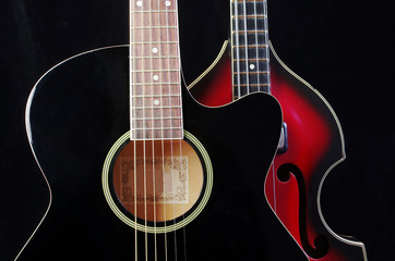 Obraz na płótnie Canvas Acoustic guitar and bass guitar on the dark