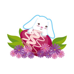 cute rabbit with easter egg painted in the garden