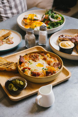 Eggs Benedict, Crispy Bacon stuffed French toast, Cheesy Potato with Crispy Bacon and Pancakes with Maple Syrup, Bacon and Vanilla Ice Cream. Served with Hot Latte.