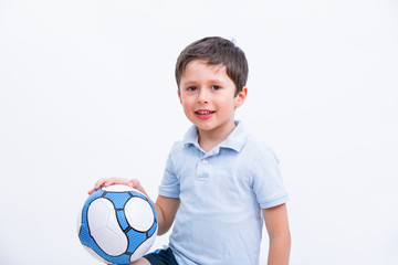 Happy boy playing football. Cute child, young male teen goalkeeper enjoying sport game. Little footballer holding ball, isolated portrait on white background. Kid having fun from sport activity.