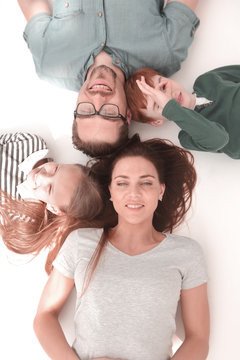top view. happy parents with children to relax by lying on the floor