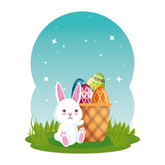 cute rabbit with easter eggs painted in basket