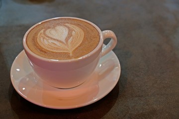 A cup of latte, cappuccino or espresso coffee with milk put on a table.