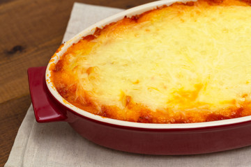 Shepherd's pie, traditional dish with minced meat and mashed potato on wooden table