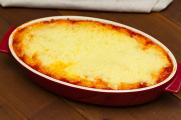 Shepherd's pie, traditional dish with minced meat and mashed potato on wooden table