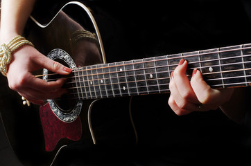 Fototapeta na wymiar Female hands playing guitar