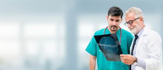 Doctors at hospital working with another doctor. Healthcare and medical people services concept.