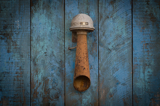 Rusty Airhorn On A Teal Background