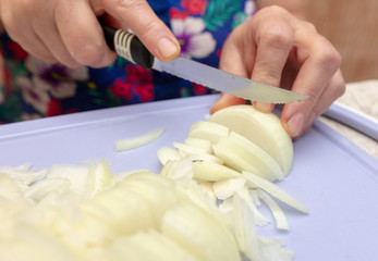Woman cuts a bow with a knife