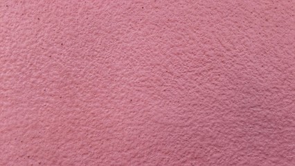 Abstract background of pink cement wall.