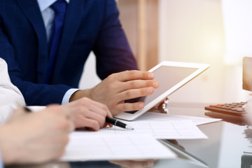 Businessman using laptop at meeting, closeup of hands. Business operations concept