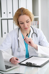 Doctor woman at work. Physician filling up medical history records form at the desk. Medicine, healthcare  concept