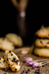 homemade cookies with chocolate drops filling on a black background