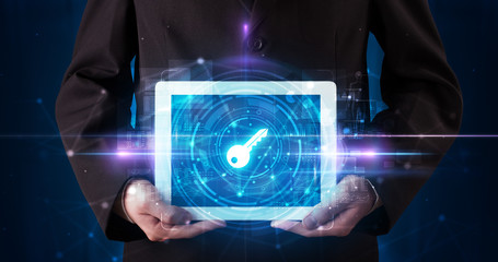 Hand holding tablet with online security and data protection concept
