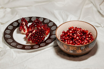 Opened cutted pomegranate on the red board