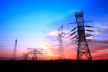In the evening, the silhouette of high voltage towers