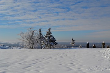 Stone statues of Polovtsian women on top of the mountain Kremyanets against the patterned winter sky. Back view. Winter landscape