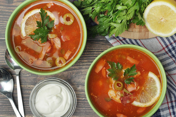 Two bowls with traditional Russian soup solyanka