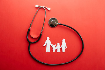 Family health / life insurance concept. Paper chain in form of family, mother, father, son &...