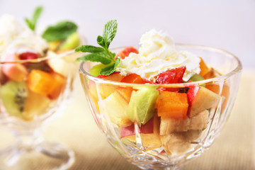 Diet-Fresh tasty mix fruit salad in the bowl on the wooden table, healthy breakfast, weight loss concept.