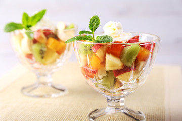 Diet-Fresh tasty mix fruit salad in the bowl on the wooden table, healthy breakfast, weight loss concept.