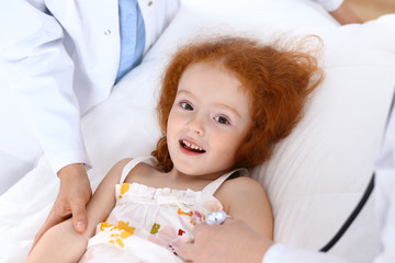Obraz na płótnie Canvas Doctor examining a little girl with stethoscope.Medicine and healthcare concept