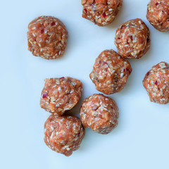Raw meatballs on baking  paper, ready for roasting. Concept- cooking, recipes, delicious dishes.