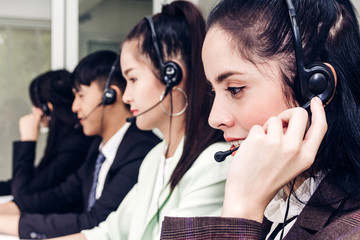 Beautiful businesswoman customer support services working with headset and computer at call center