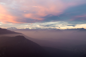Alpine chain with Monte Rosa, colorful sunset with mist, Italy