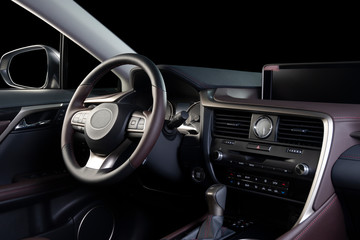 Obraz na płótnie Canvas Car interior luxury. Beige comfortable seats, steering wheel, dashboard, climate control, speedometer, display, wood decoration, isolated on black, clipping path included