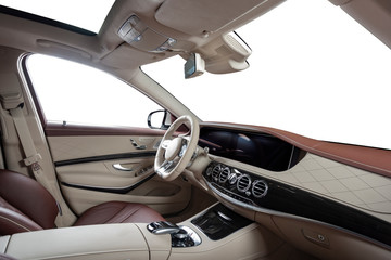 Car interior luxury. Beige comfortable seats, steering wheel, dashboard, climate control, speedometer, display, wood decoration, isolated on white, clipping path included