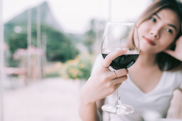 wine tasting tourist woman.Young Woman drinking wine in  Italian style restaurant