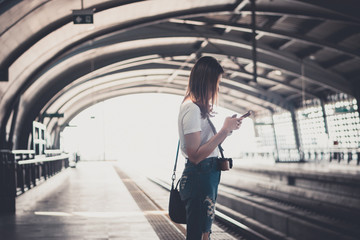 Woman waiting on the station platform at the airport link station.