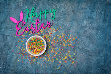 Color text of happy easter with sugar sprinkles or confetti as decor for bakery