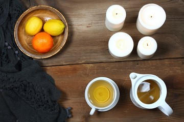 Hygge autumn or winter time for tea. Flat lay with candles, lemon and tangerin