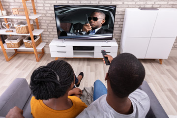 Happy African Couple Watching Television