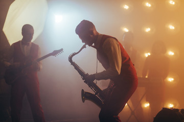 emotional musician with sax during the consert. close up side view photo. enjoyment. people, star...